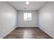 Simple bedroom with wood-look flooring and window at 41208 W Bravo Dr, Maricopa, AZ 85138