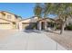 Single-story home with a two-car garage and landscaped front yard at 41208 W Bravo Dr, Maricopa, AZ 85138