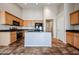 Modern kitchen with light wood cabinets, an island, and stainless steel appliances at 41208 W Bravo Dr, Maricopa, AZ 85138