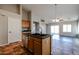 Kitchen features an island, light wood cabinets, and a tile floor at 41208 W Bravo Dr, Maricopa, AZ 85138