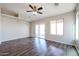 Living room with sliding glass doors and ceiling fan at 41208 W Bravo Dr, Maricopa, AZ 85138