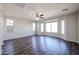 Bright living room with large bay window and wood-look flooring at 41208 W Bravo Dr, Maricopa, AZ 85138