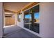 Covered patio with sliding glass doors and access to interior at 41208 W Bravo Dr, Maricopa, AZ 85138