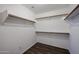 Spacious walk-in closet with shelving and hanging rods at 41208 W Bravo Dr, Maricopa, AZ 85138