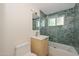 Updated bathroom with teal mosaic tile and a modern vanity at 6312 N 13Th St, Phoenix, AZ 85014