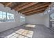 Room with exposed wood beams, windows, and sliding glass doors at 6312 N 13Th St, Phoenix, AZ 85014