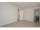 Bright bedroom with wood-look floors and an adjacent bathroom at 6312 N 13Th St, Phoenix, AZ 85014