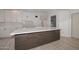 Modern kitchen island with white quartz countertops and dark cabinets at 6312 N 13Th St, Phoenix, AZ 85014