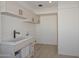 Laundry room with modern sink and light wood cabinets at 6312 N 13Th St, Phoenix, AZ 85014