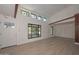 Living room with large windows, wood accent wall, and vaulted ceilings at 6312 N 13Th St, Phoenix, AZ 85014