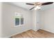 Well-lit bedroom featuring wood-look floors, a ceiling fan, and ample closet space at 725 W Cinnabar Ave, Phoenix, AZ 85021