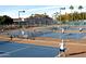 Community tennis courts with players at 7750 E Broadway Rd # 697, Mesa, AZ 85208