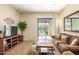 Living room with patio access, comfy seating, and a large TV at 846 N Pueblo Dr # 113, Casa Grande, AZ 85122