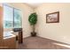 Home office with wood desk and large plant at 846 N Pueblo Dr # 113, Casa Grande, AZ 85122