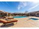 Community pool and spa with lounge chairs at 846 N Pueblo Dr # 113, Casa Grande, AZ 85122