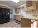 Galley kitchen with ample counter space and black appliances at 10701 W Salem Dr, Sun City, AZ 85351