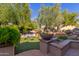 Landscaped backyard with seating area and lush greenery at 12832 W Pinnacle Vista Dr, Peoria, AZ 85383