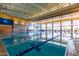 Indoor lap pool with large windows and high ceilings at 12832 W Pinnacle Vista Dr, Peoria, AZ 85383