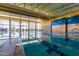 Indoor lap pool with large windows and high ceilings at 12832 W Pinnacle Vista Dr, Peoria, AZ 85383