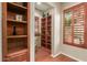 Home office with built-in shelving and plantation shutters at 12832 W Pinnacle Vista Dr, Peoria, AZ 85383