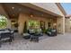 Covered patio with seating area and outdoor dining at 12832 W Pinnacle Vista Dr, Peoria, AZ 85383