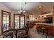 Charming dining area with a glass-top table and kitchen views at 13108 N 76Th St, Scottsdale, AZ 85260