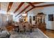 Elegant dining room with hardwood floors, a wood beam ceiling, and a large dining table at 13108 N 76Th St, Scottsdale, AZ 85260