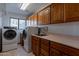Laundry room with washer, dryer, and cabinets at 13108 N 76Th St, Scottsdale, AZ 85260
