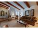Spacious living room with hardwood floors, a wood beam ceiling and comfortable seating at 13108 N 76Th St, Scottsdale, AZ 85260
