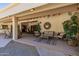 Relaxing covered patio with seating area and lush plants at 13108 N 76Th St, Scottsdale, AZ 85260