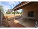 Landscaped backyard with covered patio and brick pavers at 13652 W Fargo Dr, Surprise, AZ 85374