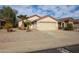 House exterior featuring a two-car garage and drought-tolerant landscaping at 13652 W Fargo Dr, Surprise, AZ 85374