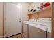 Convenient laundry room with washer, dryer, and shelving at 13652 W Fargo Dr, Surprise, AZ 85374