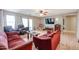 Spacious living area with two sofas, a large TV, and access to the backyard at 13652 W Fargo Dr, Surprise, AZ 85374