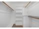 Walk-in closet with wood shelving and hanging rods at 1449 E Highland Ave # 36, Phoenix, AZ 85014