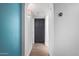 Clean hallway with gray cabinets and teal accent wall at 1449 E Highland Ave # 36, Phoenix, AZ 85014