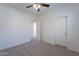 Well-lit bedroom with ceiling fan and access to another room at 18522 W Mountain View Rd, Waddell, AZ 85355