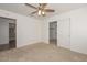 Bedroom with ceiling fan, sliding closet doors and view of bathroom at 20058 N 109Th Dr, Sun City, AZ 85373