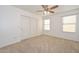 Bright bedroom with ceiling fan, double door closet and window blinds at 20058 N 109Th Dr, Sun City, AZ 85373