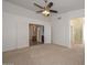 Main bedroom with ceiling fan and ensuite bathroom at 20058 N 109Th Dr, Sun City, AZ 85373