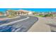 Community entrance with curved driveway and landscaping at 20058 N 109Th Dr, Sun City, AZ 85373