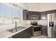 Kitchen with stainless steel appliances and double sink at 20058 N 109Th Dr, Sun City, AZ 85373