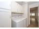 Laundry room with washer, dryer, cabinets and access to other rooms at 20058 N 109Th Dr, Sun City, AZ 85373