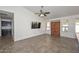 Bright living room with tile floors and a ceiling fan at 20058 N 109Th Dr, Sun City, AZ 85373