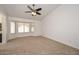 Living room with bay window and ceiling fan at 20058 N 109Th Dr, Sun City, AZ 85373