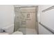 Walk-in shower with tiled walls and grab bars at 20058 N 109Th Dr, Sun City, AZ 85373