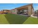 Landscaped backyard with covered patio, pergola, and playset at 22446 E Russet Rd, Queen Creek, AZ 85142