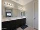 Double vanity bathroom with dark wood cabinets at 22446 E Russet Rd, Queen Creek, AZ 85142