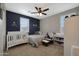 bedroom with crib, dresser, and calming blue and grey decor at 22446 E Russet Rd, Queen Creek, AZ 85142