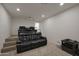 Home theater with tiered seating and projector at 22446 E Russet Rd, Queen Creek, AZ 85142
